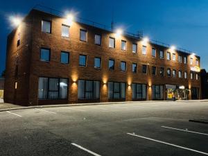 an empty parking lot in front of a brick building at Motel Air Glasgow Airport in Paisley