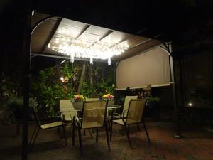 a table and chairs under a pavilion at night at Suite Dreams Inn by the Beach in Key West +31 photos