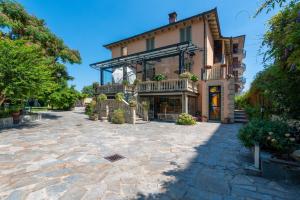 a large house with a patio in front of it at Villa Mery in Casale Monferrato