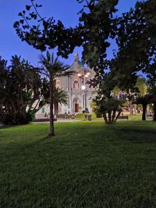a large white building with trees in a park at Casa 900 in Pompei