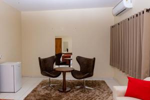 a living room with chairs and a table and a couch at Village Hotel in Cáceres