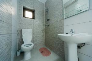 a bathroom with a toilet and a sink at Casa Erty in Eforie Nord +18 photos