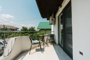 a balcony with two chairs and a table on it at Casa Erty in Eforie Nord