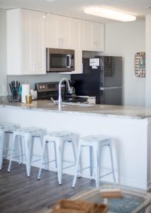 a kitchen with white cabinets and a white counter top at Grand Beach Resort Unit 313 in Gulf Shores