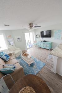 a living room with a couch and a tv at Grand Beach Resort Unit 313 in Gulf Shores