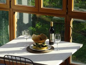 a table with a plate of food and a bottle of wine at Castro Urdiales - LA VIEJA ESTACIÓN - Cerca de Bilbao in Castro-Urdiales