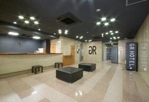 a lobby with a bar in a building at GR Hotel Suidocho in Kumamoto