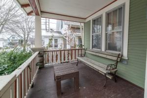 a porch with a bench on a house at Comfortable 3 BR Craftsman Bungalow in Milwaukee's Bay View Neighborhood in Milwaukee