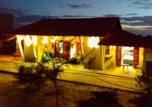 a house lit up at night with lights on it at Flats Macapá Meu Amor in Luis Correia