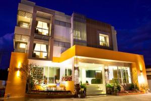 a building with a lit up facade at night at La Belle in Chiang Rai
