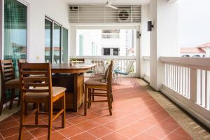 a balcony with a table and chairs and windows at Profolio @ Straits Quay in George Town
