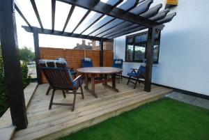 a patio with a table and chairs on a deck at Clifton Bridge Hotel in York