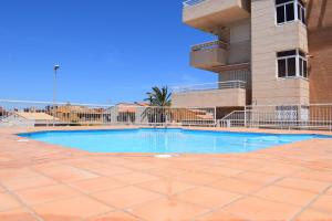 a swimming pool in front of a building at Sector 5 Napols AP844 in Oliva