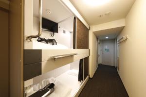 a small bathroom with a sink and a mirror at Dormy Inn EXPRESS Asakusa in Tokyo