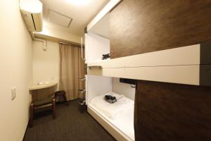 a small room with a bed and a desk at Dormy Inn EXPRESS Asakusa in Tokyo +75 photos