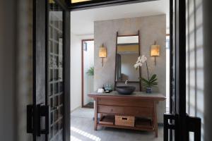 a bathroom with a sink and a mirror at Anantara Lawana Koh Samui Resort in Chaweng