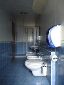 a bathroom with three toilets and a sink at Tea Palace Hotel in Casapulla +13 photos