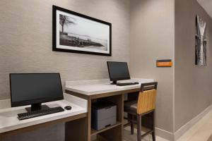 a room with a desk with a computer and a monitor at La Quinta by Wyndham Rock Hill in Rock Hill