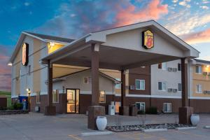 a hotel with a sign in front of a building at Super 8 by Wyndham Gillette in Gillette