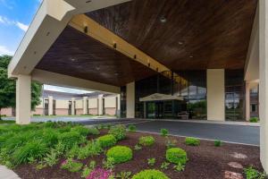 a large building with a large wooden roof at Baymont by Wyndham Elkhart in Elkhart