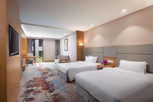 
A bed or beds in a room at Ramada by Wyndham Beijing Airport
