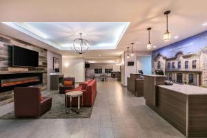 a lobby of a hospital with chairs and a bar at La Quinta by Wyndham Fredericksburg in Fredericksburg