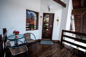 a room with a table and chairs and a door at Colț Viu Cabana in Bran
