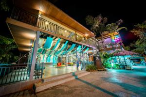 a night view of a building with lights at Aman Tioman Beach Resort in Tioman Island