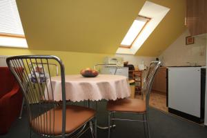 a kitchen with a table with an apple on it at Apartmán pod Černou horou in Rožnov pod Radhoštěm