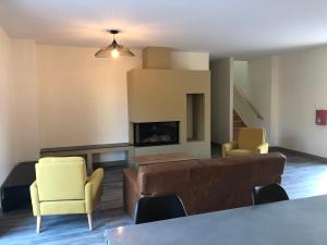 a living room with a couch and two chairs at Le domaine de la carperie in Bréhal