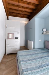 a bedroom with a bed and a wooden ceiling at La dimora di Filippo in Cuneo