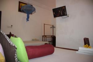 a living room with a couch and a tv at Miheen Hotel & Resort - Anuradhapura in Mihintale