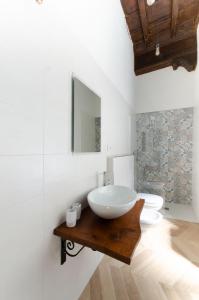 a bathroom with a sink and a mirror at La dimora di Filippo in Cuneo