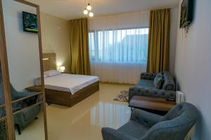 a bedroom with a bed and a mirror at Summer Villa in Vama Veche