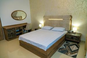 a bedroom with a large bed and a mirror at Summer Villa in Vama Veche