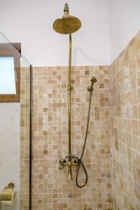 a shower with a shower head in a bathroom at Summer Villa in Vama Veche +29 photos