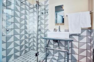 a bathroom with a sink and a shower at Cozy, Modern Living in Maboneng: Artison Lofts 105 in Johannesburg