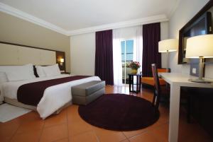 
a hotel room with two beds and a table at Kenzi Europa in Agadir
