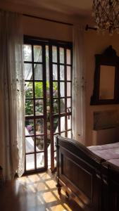 a bedroom with an open door to a garden at B&B Al Roncaccio in Calco