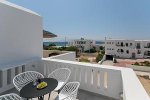 a balcony with a table and chairs and a view at Iades Studios & Apartments in Agia Anna Naxos