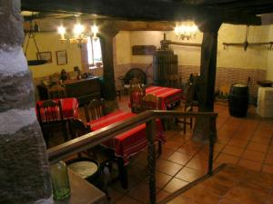 a restaurant with red tables and chairs in a room at Labeondo in Muskiz
