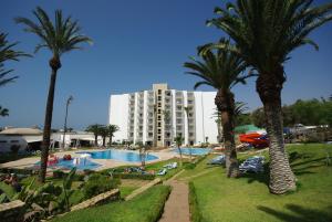 a hotel with palm trees in front of a pool at TUI SUNEO Kenzi Europa in Agadir