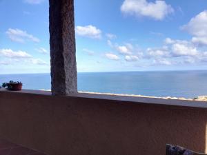a view of the ocean from a window at Una terrazza in Paradiso in Costa Paradiso