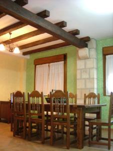 a dining room with a wooden table and chairs at Labeondo in Muskiz