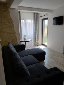 a living room with a couch and a table at Apartament CAMEL in Eforie Nord