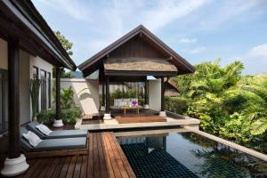 a villa with a swimming pool and a house at Anantara Lawana Koh Samui Resort in Chaweng