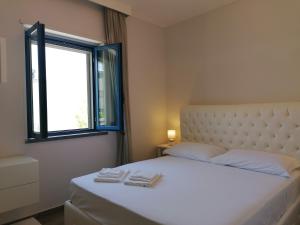 En eller flere senge i et værelse på Hotel Residence La Corvetta