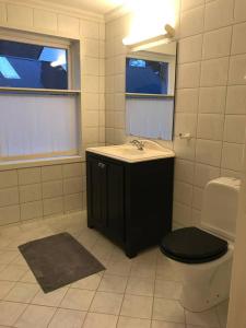 a bathroom with a sink and a toilet and a window at Moldegaard Farmhouse - Apartment B in Moldegard +11 photos
