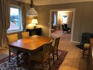 a dining room with a wooden table and chairs at Moldegaard Farmhouse - Apartment B in Moldegard