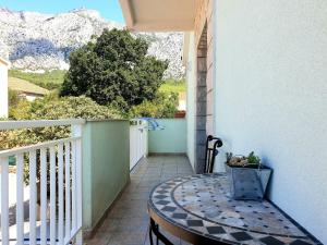 a table on a balcony with a view of mountains at Apartments Ines in Orebić